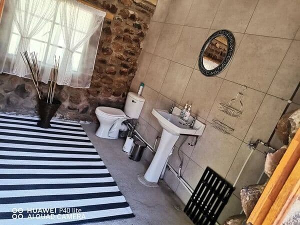 Rustic bathroom interior with striped rug